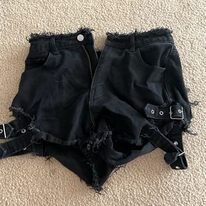 black denim shorts with straps.